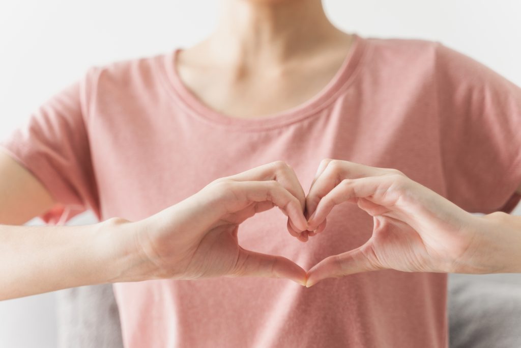 Woman making hands in heart shape
